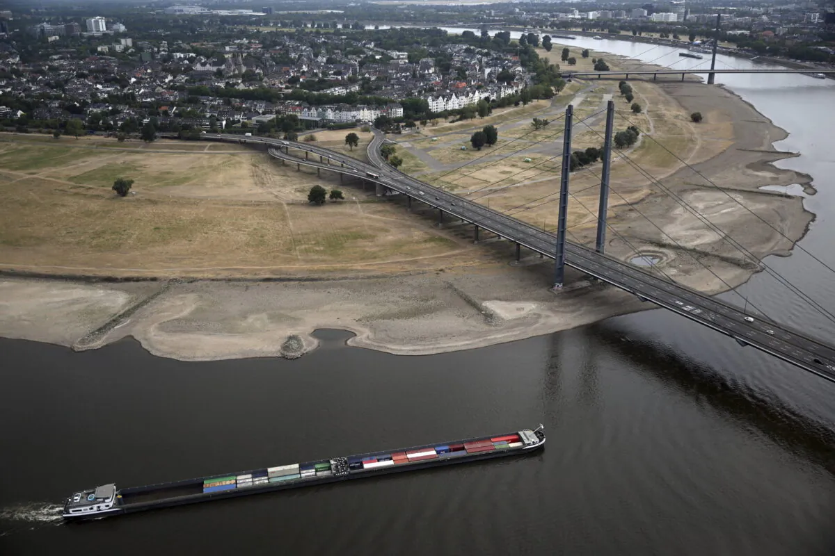 A cargo ship is sailing on the Rhine in Duesseldorf, Germany, Monday, Aug. 15, 2022. Due to the ongoing drought, the Rhine level has reached a low. The Rhine level near Cologne was 76 centimeters (low: 69 centimeters). In Düsseldorf, 34 centimeters were measured (23 centimeters). For the coming days, even further falling water levels are expected. (Federico Gambarini/dpa via AP)
