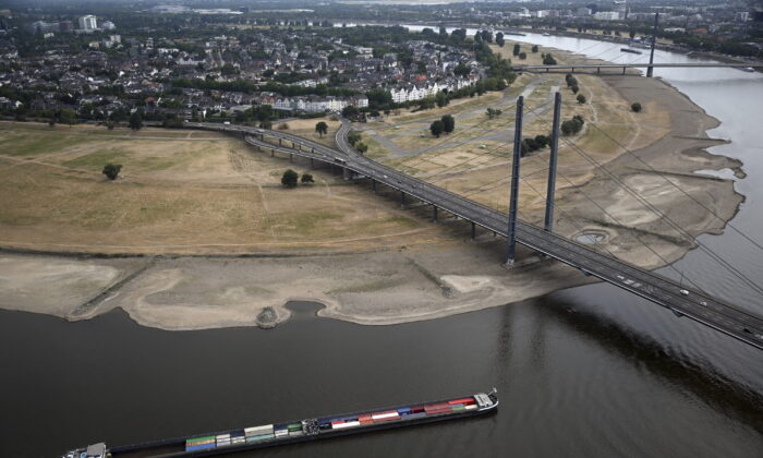 A cargo ship is sailing on the Rhine in Duesseldorf, Germany, Monday, Aug. 15, 2022. Due to the ongoing drought, the Rhine level has reached a low. The Rhine level near Cologne was 76 centimeters (low: 69 centimeters). In Düsseldorf, 34 centimeters were measured (23 centimeters). For the coming days, even further falling water levels are expected. (Federico Gambarini/dpa via AP)