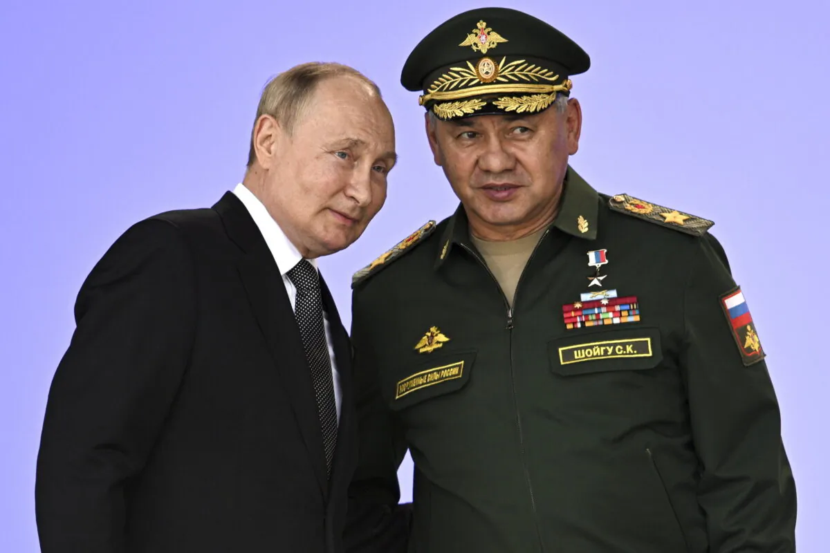Russia's President Vladimir Putin and Russian Defense Minister Sergei Shoigu attend the opening of the Army 2022 International Military and Technical Forum in the Patriot Park outside Moscow, on Aug. 15, 2022. (Sputnik/Kremlin Pool Photo via AP)