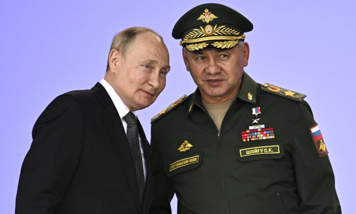 Russia's President Vladimir Putin and Russian Defense Minister Sergei Shoigu attend the opening of the Army 2022 International Military and Technical Forum in the Patriot Park outside Moscow, on Aug. 15, 2022. (Sputnik/Kremlin Pool Photo via AP)
