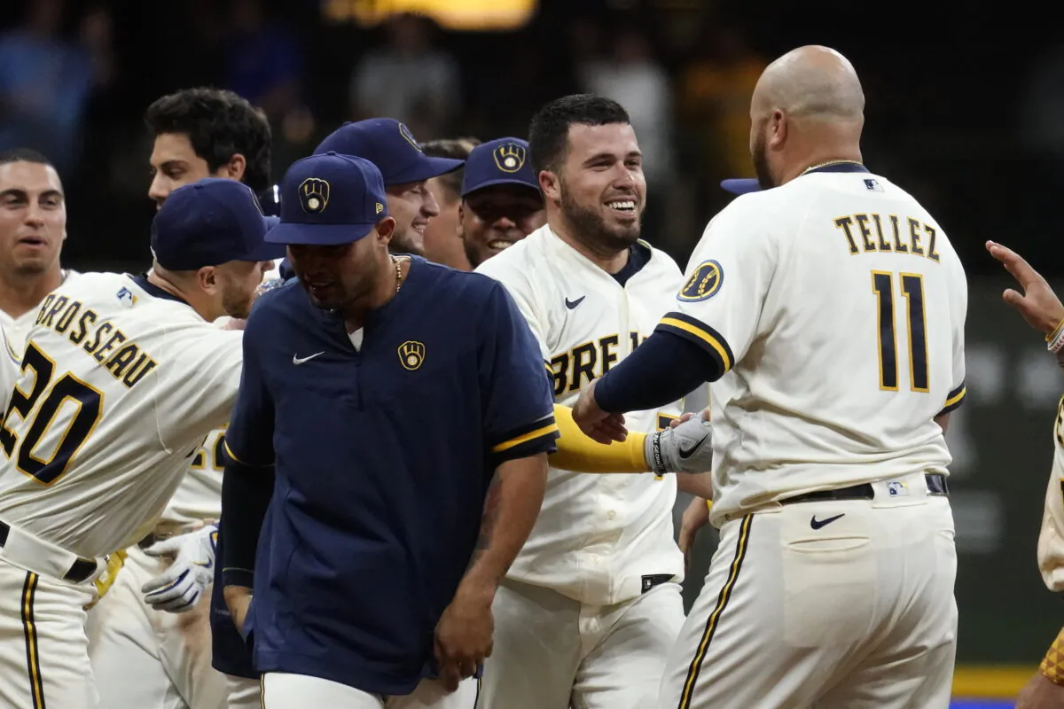 Milwaukee Brewers' Victor Caratini, second from right, is congratulated by teammates after his two-run single during the 11th inning of the team's baseball game against the Los Angeles Dodgers in Milwaukee, Aug. 16, 2022. (Aaron Gash/AP Photo)