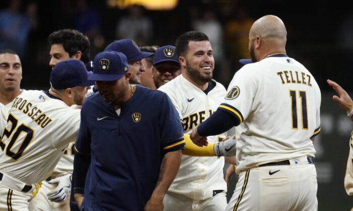 Milwaukee Brewers' Victor Caratini, second from right, is congratulated by teammates after his two-run single during the 11th inning of the team's baseball game against the Los Angeles Dodgers in Milwaukee, Aug. 16, 2022. (Aaron Gash/AP Photo)