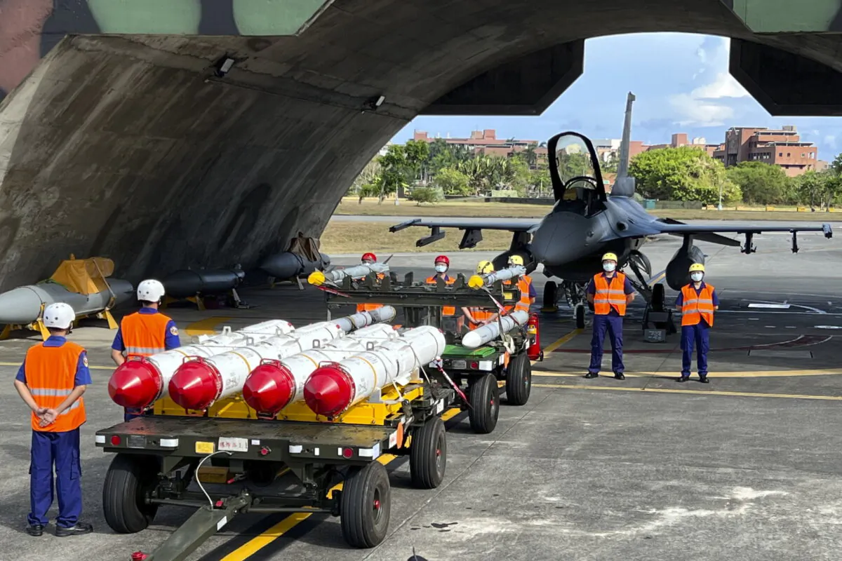 Military personnel stand next to Harpoon A-84, anti-ship missiles and AIM-120 and AIM-9 air-to-air missiles prepared for a weapon loading drills in front of a F16V fighter jet at the Hualien Airbase in Taiwan's southeastern Hualien county on Wednesday, Aug. 17, 2022. (AP Photo/Johnson Lai)