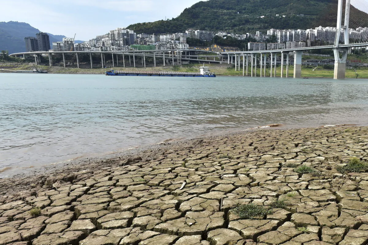 A dried riverbed is exposed after the water level dropped in the Yangtze River in Yunyang county in southwest China's Chongqing Municipality, on Aug. 16, 2022. (Chinatopix Via AP)
