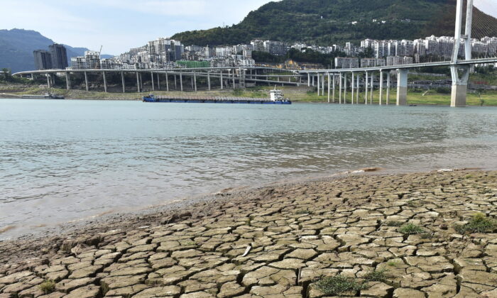 A dried riverbed is exposed after the water level dropped in the Yangtze River in Yunyang county in southwest China's Chongqing Municipality, on Aug. 16, 2022. (Chinatopix Via AP)