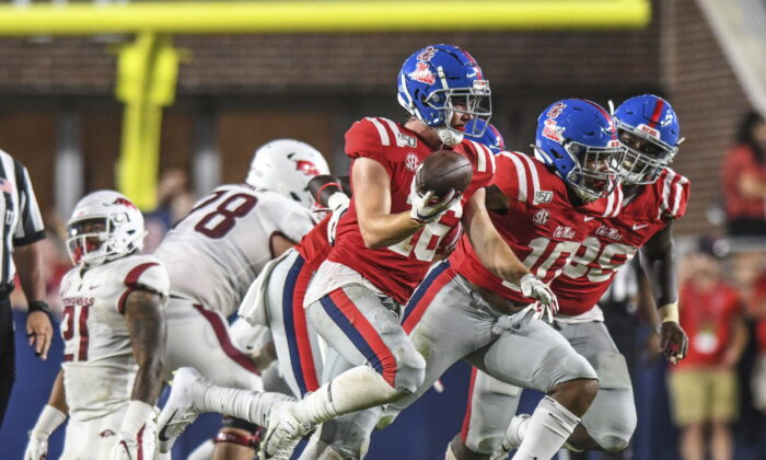 Mississippi linebacker Luke Knox (16) celebrates a fumble recovery against Arkansas during an NCAA college football game in Oxford, Miss., on Sept. 7, 2019.  (Bruce Newman/The Oxford Eagle via AP)