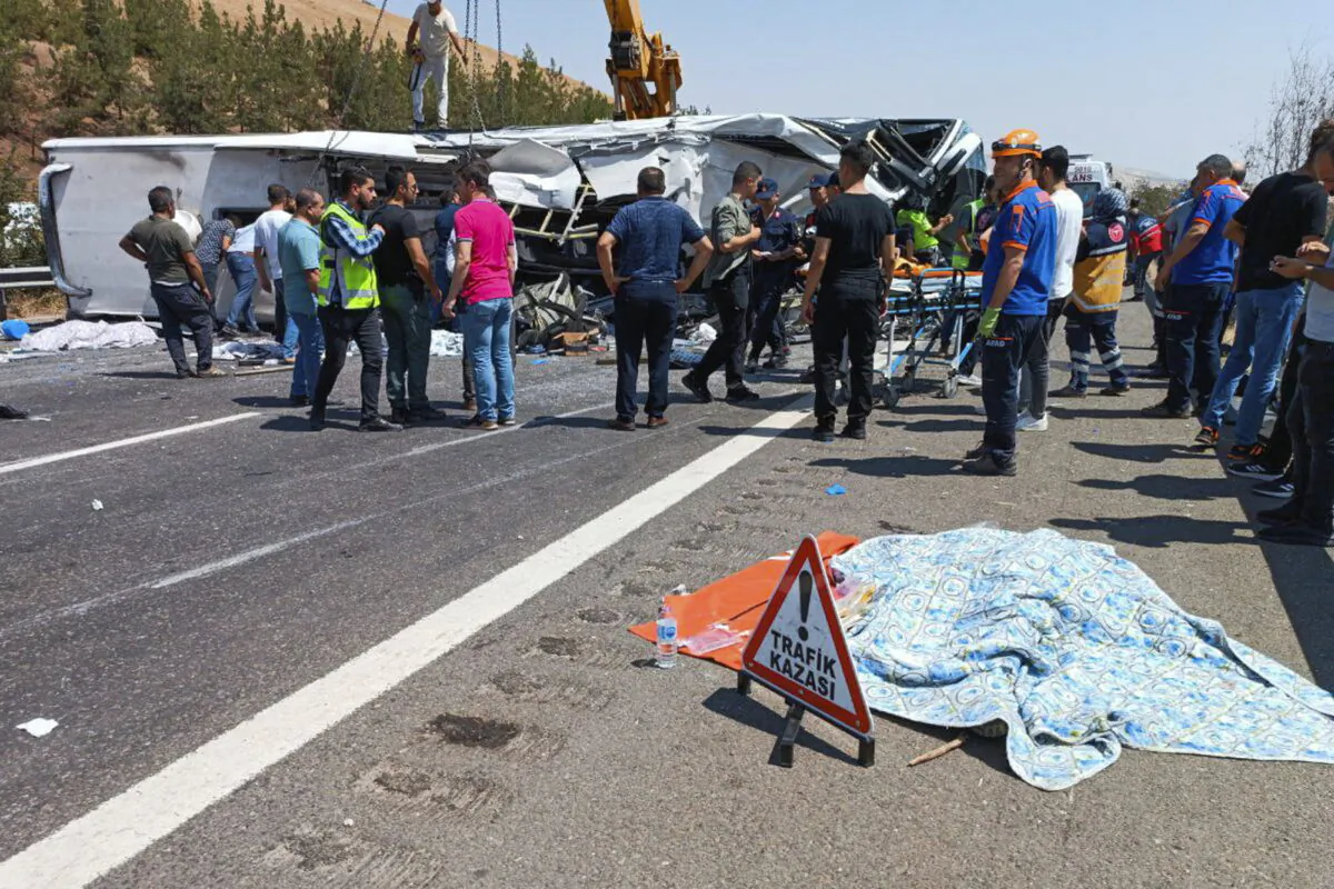 Emergency and rescue teams attend the scene after a bus crash accident on the highway between Gaziantep and Nizip, Turkey, on Aug. 20, 2022. (IHA via AP)