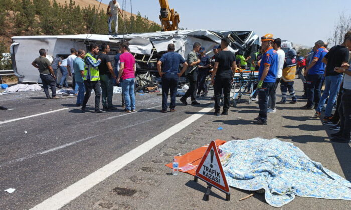Emergency and rescue teams attend the scene after a bus crash accident on the highway between Gaziantep and Nizip, Turkey, on Aug. 20, 2022. (IHA via AP)