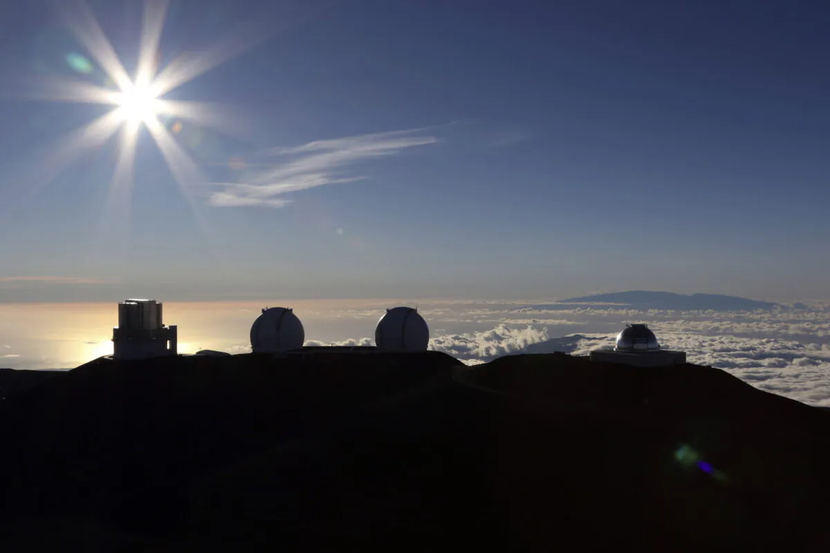 The sun sets behind telescopes at the summit of the Big Island's Mauna Kea in Hawaii on July 14, 2019. (Caleb Jones/AP Photo)
