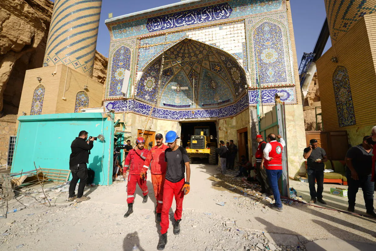 Emergency services and rescue workers are seen at Qattarat al-Imam Ali shrine near Karbala, Iraq, on Aug. 21, 2022. (Anmar Khalil/AP Photo)