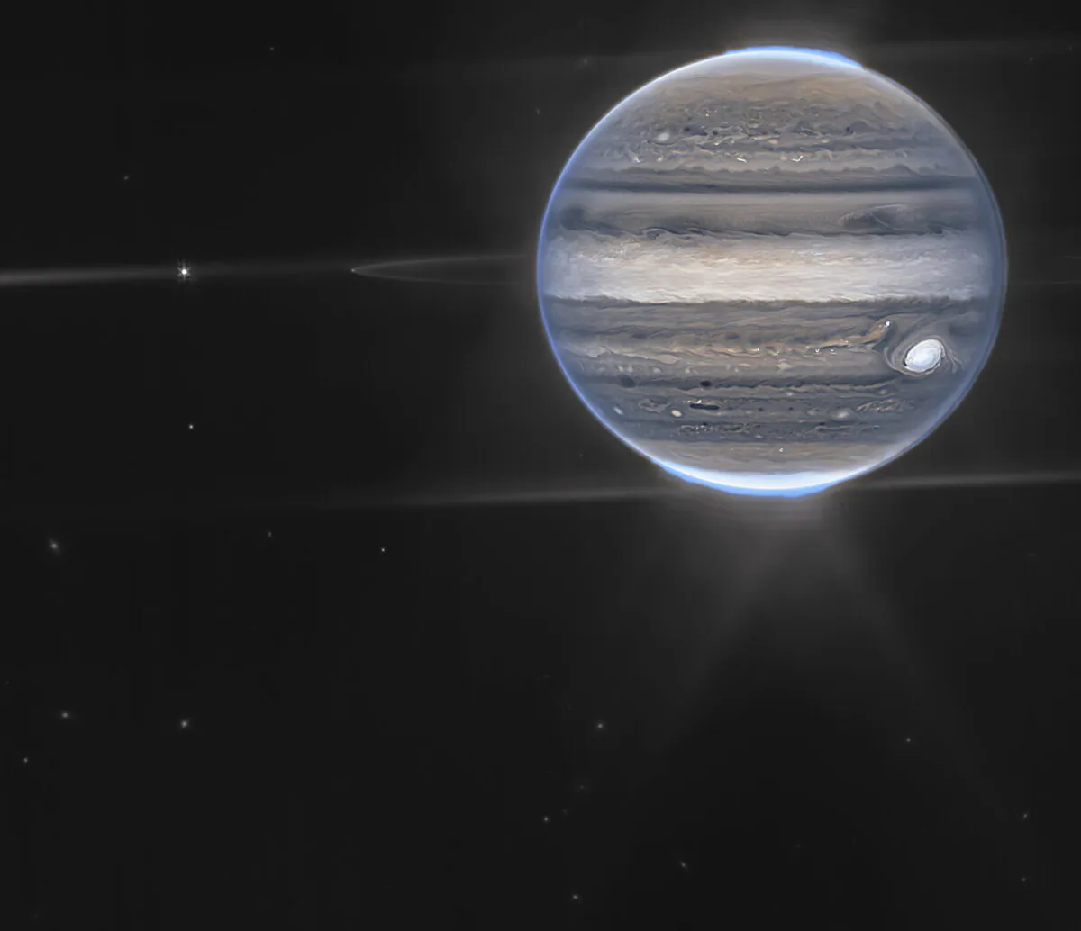 A false color composite image of Jupiter obtained by the James Webb Space Telescope on July 27, 2022. The planet’s rings and some of its small satellites are visible along with background galaxies. (NASA via AP)