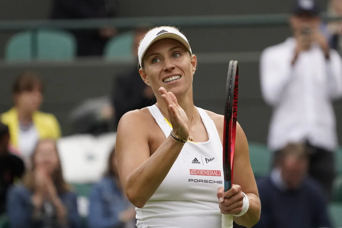 Germany's Angelique Kerber waves after defeating France's Kristina Mladenovic during their women's singles tennis match on day one of the Wimbledon tennis championships in London on June 27, 2022. (Alberto Pezzali/AP Photo)