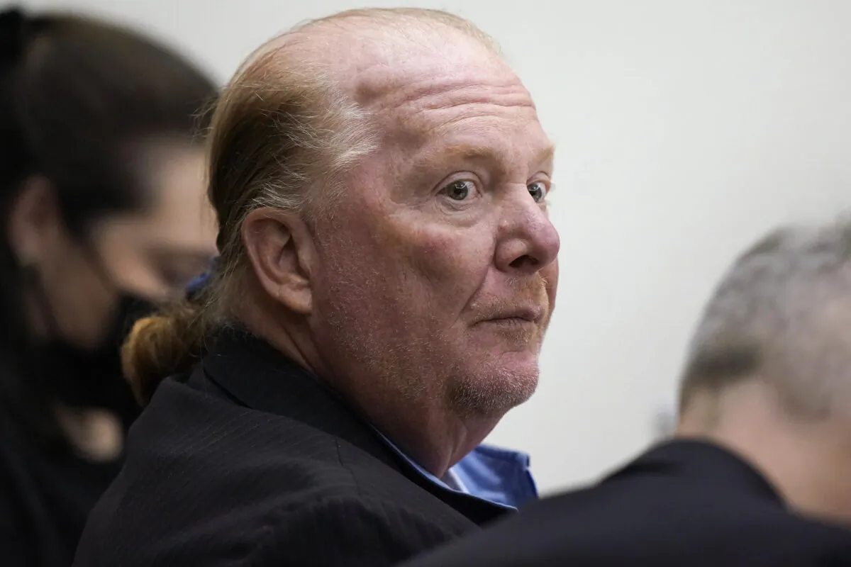 Celebrity chef Mario Batali (C) is seated at Boston Municipal Court during the first day of his pandemic-delayed trial in Boston on May 9, 2022. (Steven Senne/AP Photo, Pool)