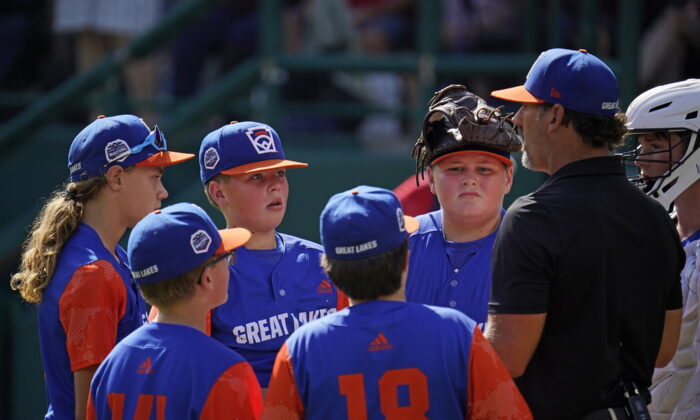 Hagerstown, Ind. manager Patrick Vinson, right, talks with his team on the mound during the second inning of a baseball game against Hollidaysburg, Pa., at the Little League World Series in South Williamsport, Pa., Aug. 23, 2022. (Gene J. Puskar/AP Photo)