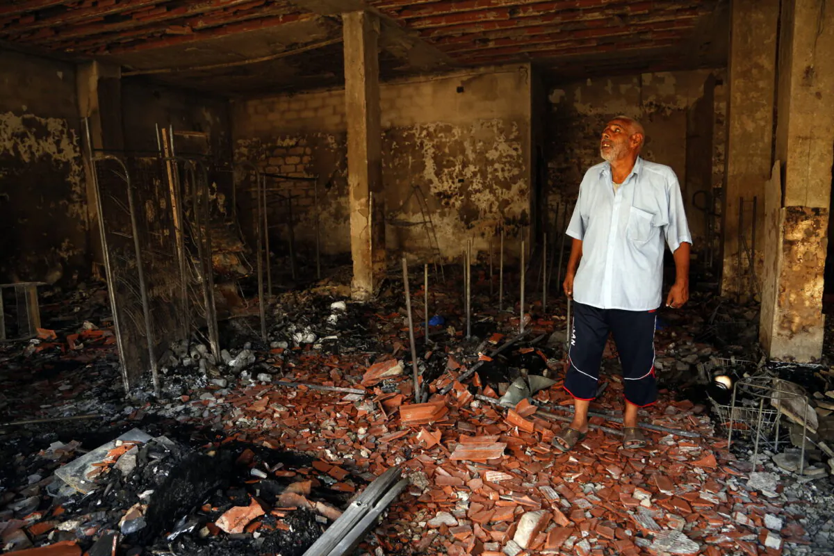 A man surveys the damage from clashes in the Libyan capital of Tripoli, on Aug. 28 2022. (Yousef Murad/AP Photo)