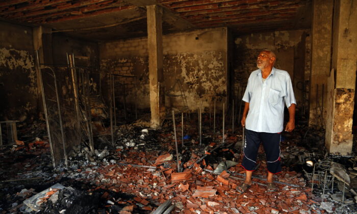 A man surveys the damage from clashes in the Libyan capital of Tripoli, on Aug. 28 2022. (Yousef Murad/AP Photo)
