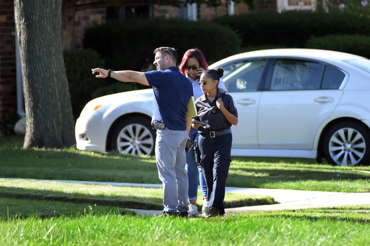 Detroit Police and investigators look over a shooting scene on Pennington Drive, north of Seven Mile Road, in Detroit, Mich., on Aug. 28, 2022. (Jose Juarez/Special to Detroit News via AP)