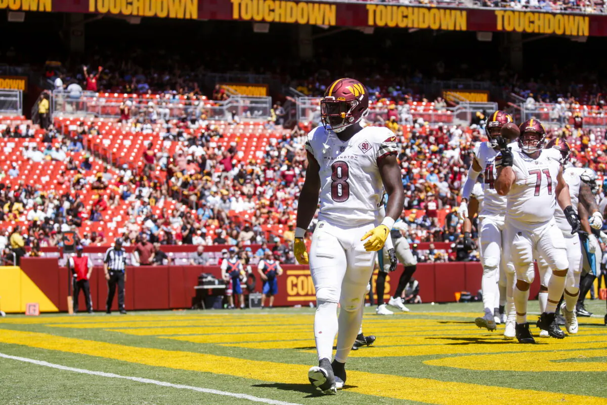 Washington Commanders running back Brian Robinson (8) celebrates his touchdown during the first half of a NFL Preseason football game between the Carolina Panthers and the Washington Commanders at FedExField in Landover, Md., Aug. 13, 2022. (Shaban Athuman/Richmond Times-Dispatch via AP)