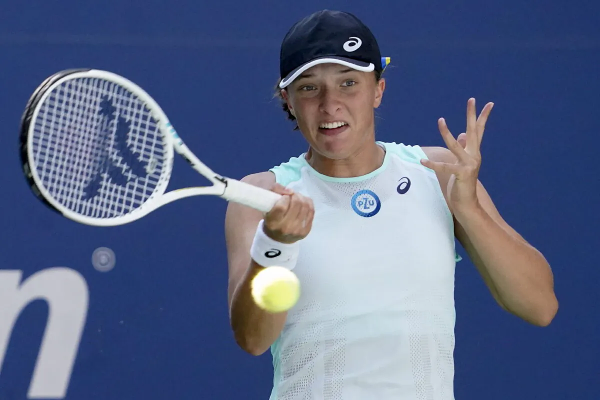 Iga Swiatek, of Poland, returns a shot to Jasmine Paolini, of Italy, during the first round of the US Open tennis championships in New York, Aug. 30, 2022. (John Minchillo/AP Photo)