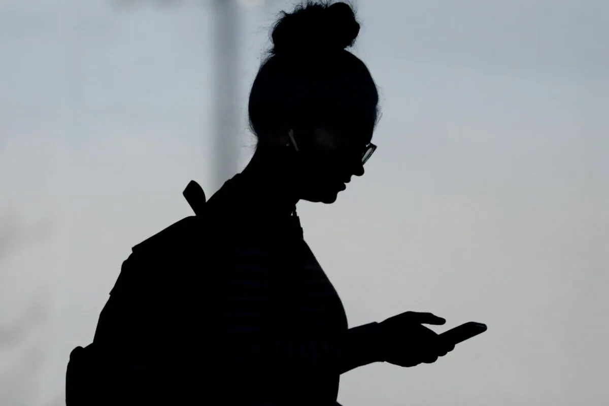 A woman checks her phone in Orem, Utah, on Nov. 14, 2019. (Rick Bowmer/AP Photo)