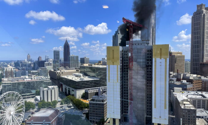 Smoke rises off a building under construction in downtown Atlanta on Aug. 31, 2022. (Mike Warren/AP Photo)