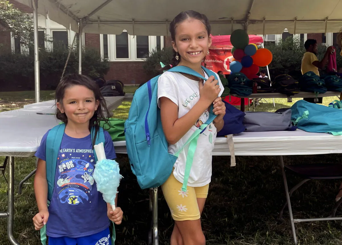 (L)Sisters Audrey and Jubilee Colon pick out new backpacks at a Chicago Public Schools back-to-school supply giveaway at Theodore Roosevelt High School in Chicago on July 22, 2022. (Claire Savage/AP Photo)