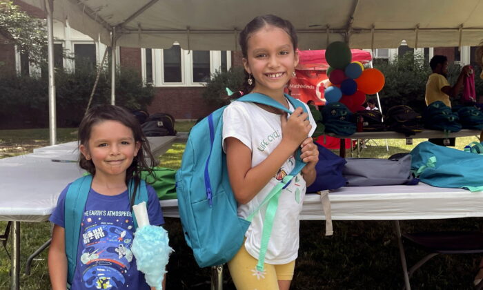 (L)Sisters Audrey and Jubilee Colon pick out new backpacks at a Chicago Public Schools back-to-school supply giveaway at Theodore Roosevelt High School in Chicago on July 22, 2022. (Claire Savage/AP Photo)