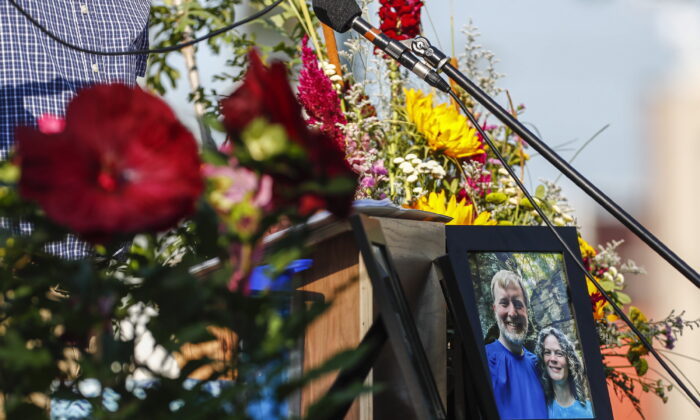 A photo of Tyler and Sarah Schmidt on the podium during the Celebration of Life event for Tyler, Sarah, and Lula Schmidt held at Overman Park in Cedar Falls, Iowa, on Aug. 2, 2022. (Chris Zoeller/The Courier via AP)