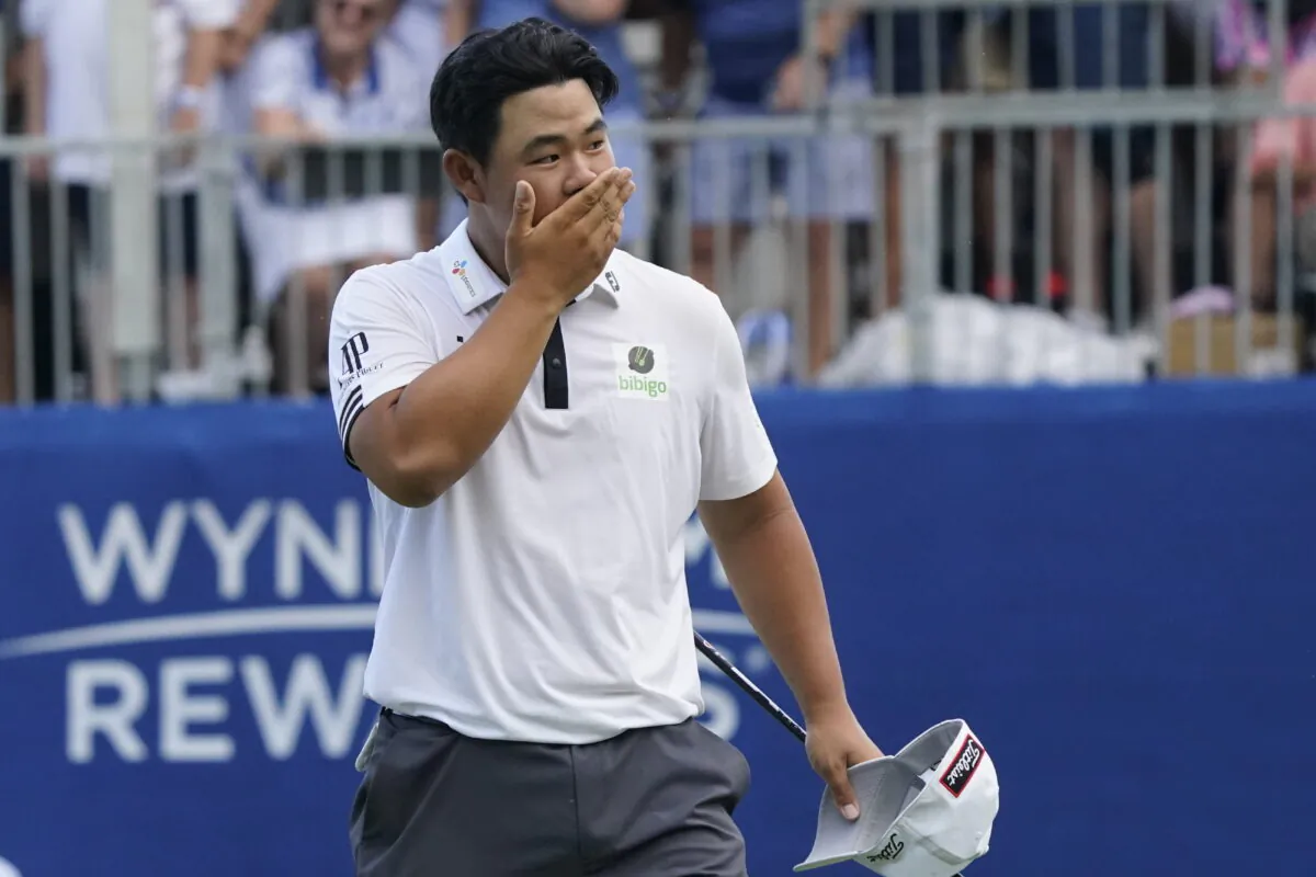 Joohyoung Kim, right, of South Korea, reacts after winning the Wyndham Championship golf tournament in Greensboro, N.C., Sunday, Aug. 7, 2022. (Chuck Burton/AP Photo)