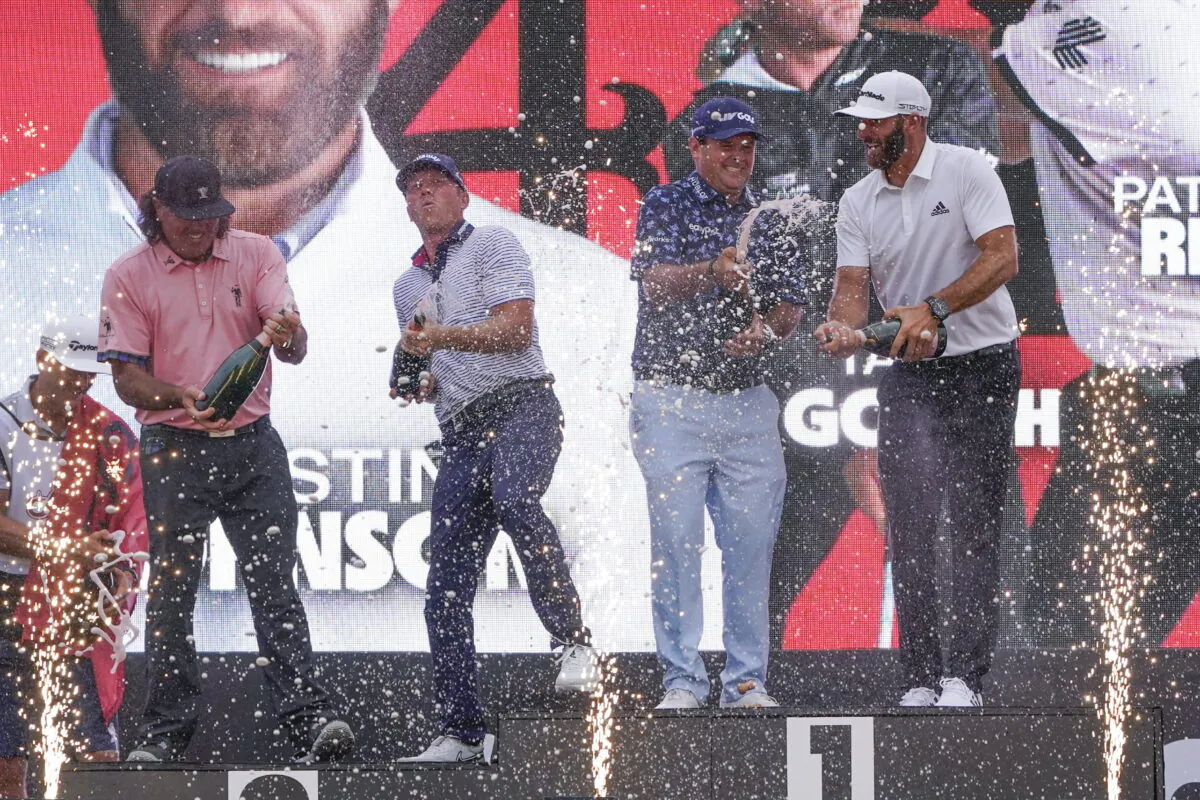The "4 Aces" team (from left to right, Pat Perez, Talor Gooch, Patrick Reed and Dustin Johnson) celebrates with champagne after winning the team competition during a ceremony after the final round of the Bedminster Invitational LIV Golf tournament in Bedminster, N.J., Sunday, July 31, 2022. (Seth Wenig/AP Photo)