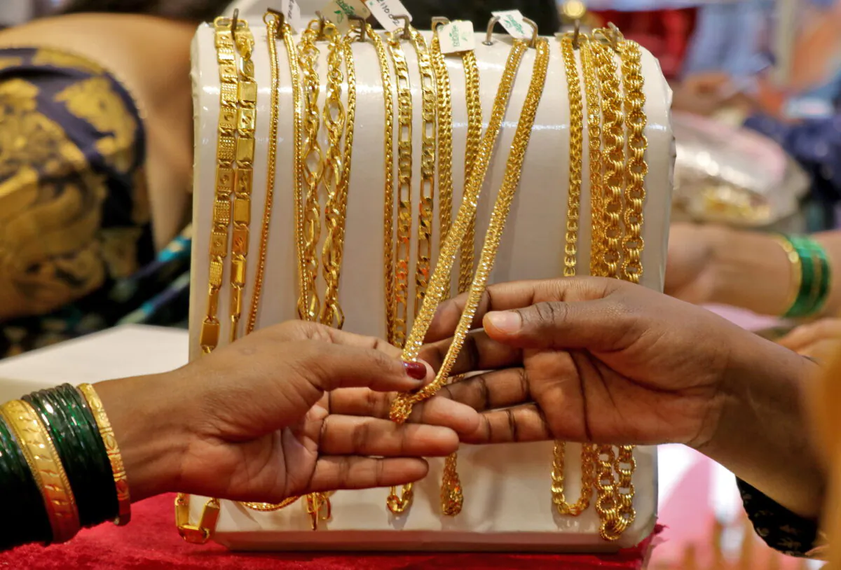 Customers check ornaments at a jewellery showroom in Mumbai, India, on Nov. 2, 2021. (Niharika Kulkarni/Reuters)