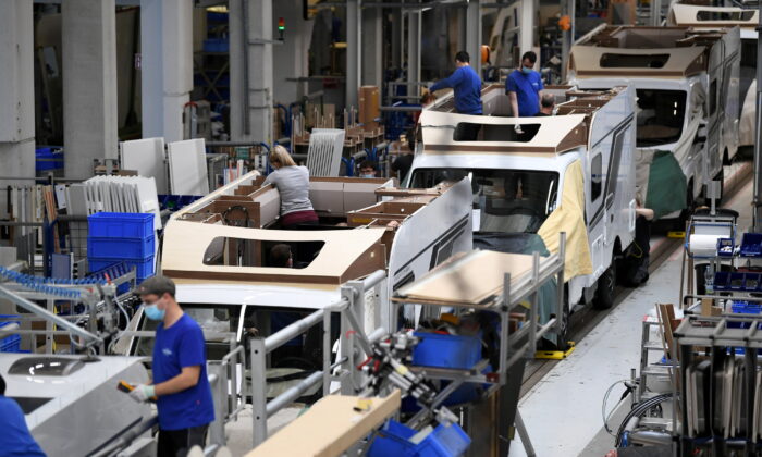 Workers assemble campers at Knaus-Tabbert AG factory in Jandelsbrunn near Passau, Germany, on March 16, 2021. (Andreas Gebert/Reuters)