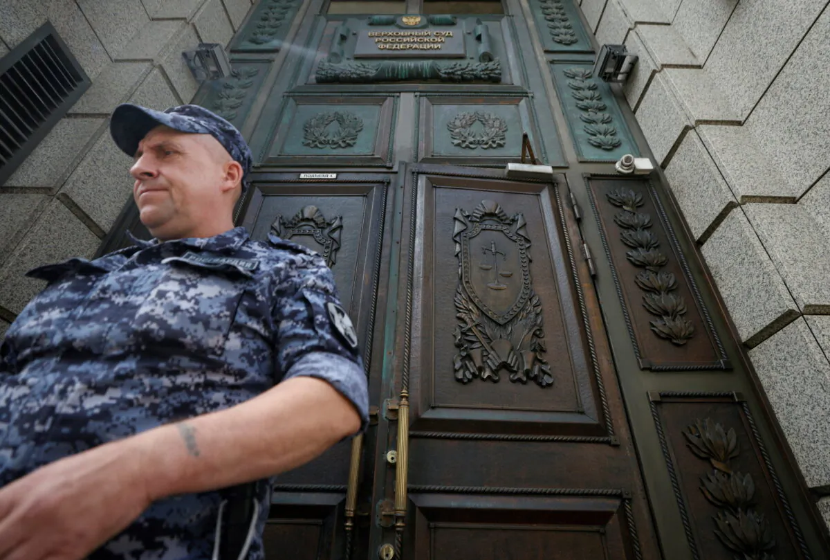 A member of the Russian National Guard leaves the building of Russia's Supreme Court before a hearing on whether to designate Ukraine's Azov Regiment as a terrorist entity in Moscow on Aug. 2, 2022. (Maxim Shemetov/Reuters)
