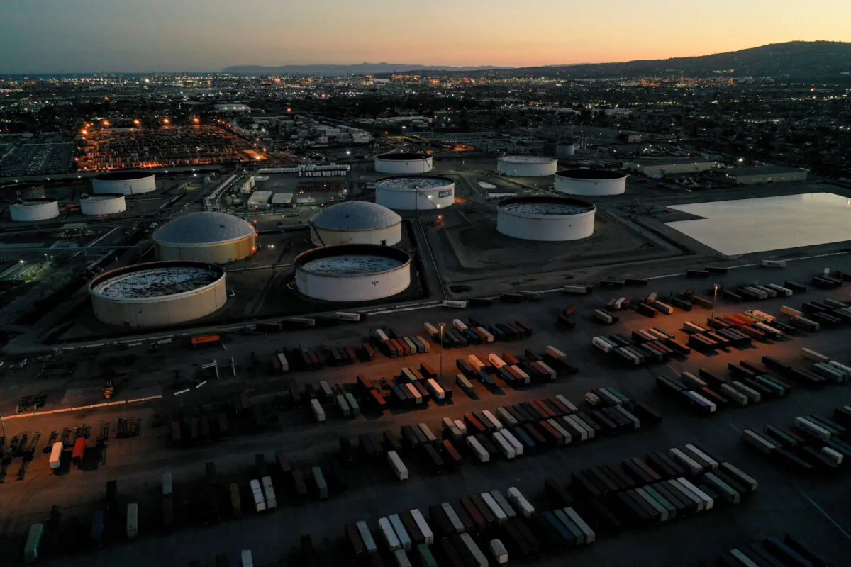 Cargo shipping containers, surrounded by storage tanks for refined petroleum products, are seen at Marathon Petroleum's Los Angeles Refinery, in Carson, Calif., on March 11, 2022. (Bing Guan/Reuters)