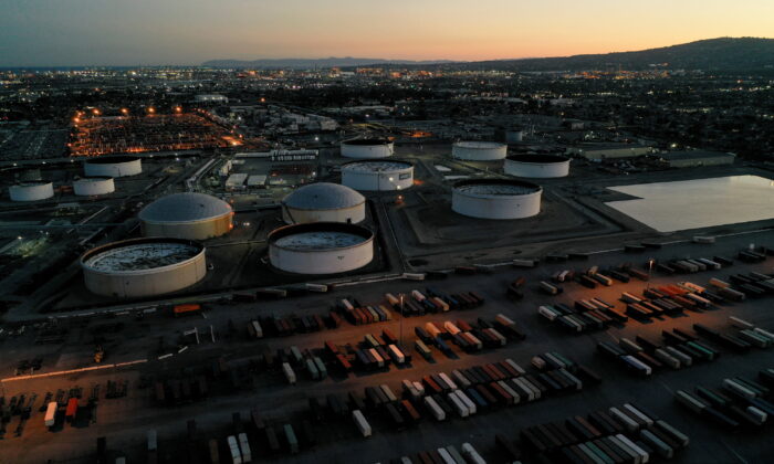 Cargo shipping containers, surrounded by storage tanks for refined petroleum products, are seen at Marathon Petroleum's Los Angeles Refinery, in Carson, Calif., on March 11, 2022. (Bing Guan/Reuters)