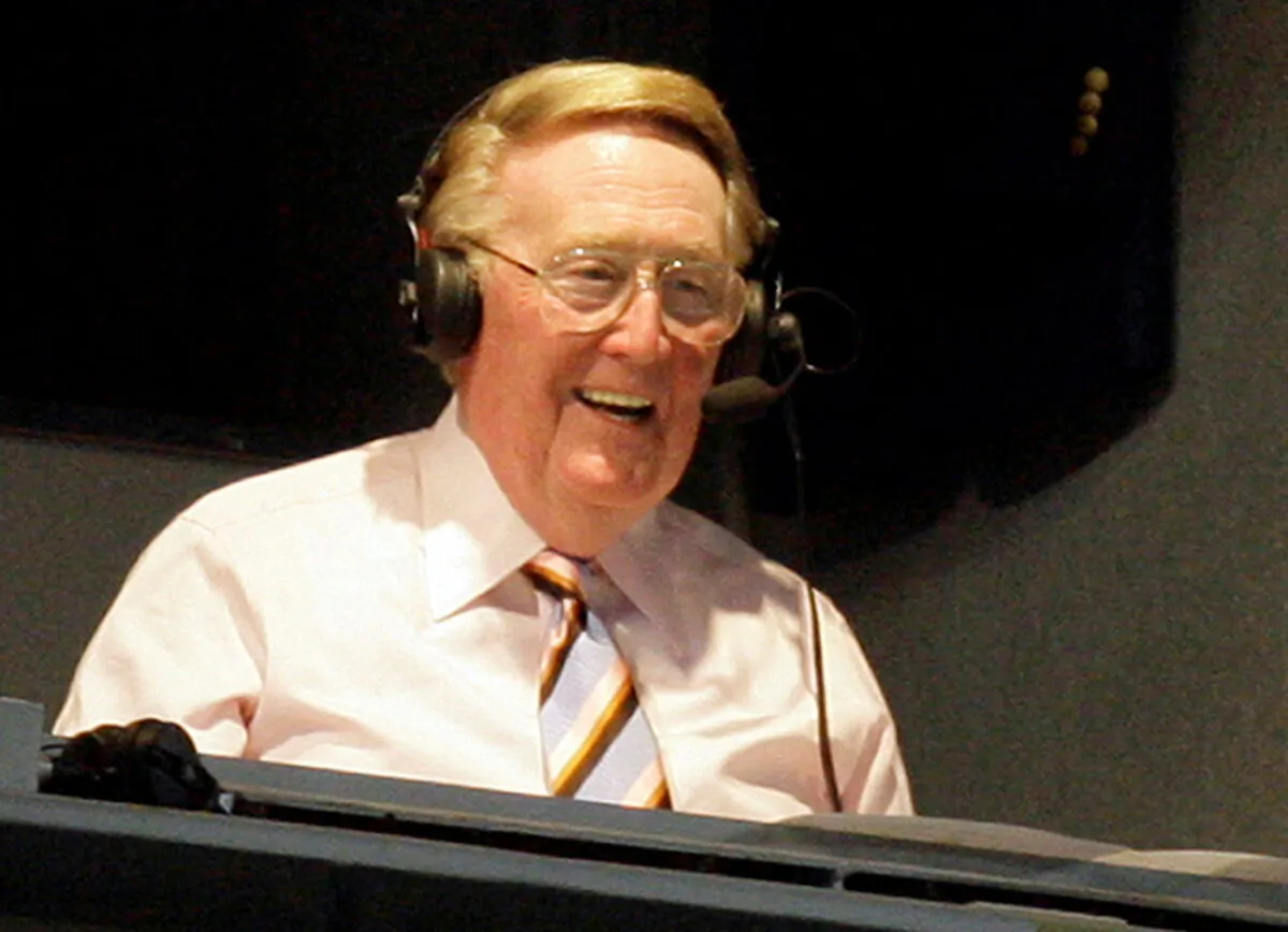 Los Angeles Dodgers announcer Vin Scully smiles in a broadcast booth during the National League MLB baseball game between the San Francisco Giants and the Los Angeles Dodgers in Los Angeles on April 25, 2007. (Danny Moloshok/Reuters)