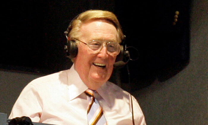Los Angeles Dodgers announcer Vin Scully smiles in a broadcast booth during the National League MLB baseball game between the San Francisco Giants and the Los Angeles Dodgers in Los Angeles on April 25, 2007. (Danny Moloshok/Reuters)