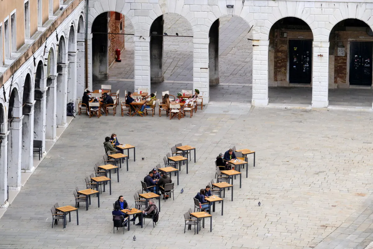 Italians enjoy aperitivo evening drinks sitting down at a bar, as coronavirus disease (COVID-19) restrictions ease, in Venice, Italy, on April 26, 2021. (Manuel Silvestri/Reuters)