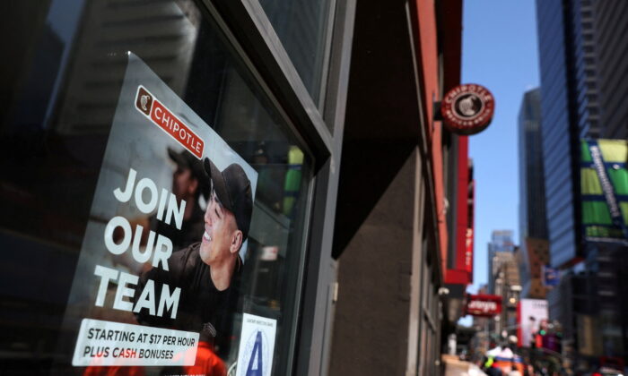 A sign for hire is posted on the window of a Chipotle restaurant in New York City, on April 29, 2022.  (REUTERS/Shannon Stapleton/File Photo)