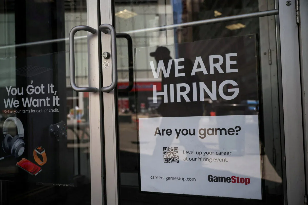 A sign for 'hiring' is posted on the door of a GameStop in New York, on April 29, 2022. (Shannon Stapleton/Reuters)