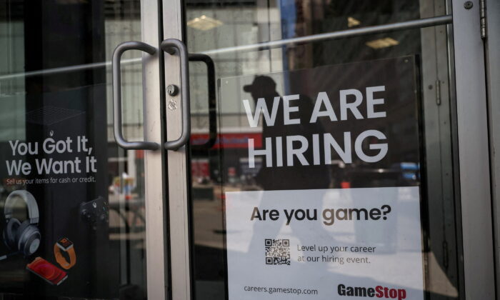 A sign for hire is posted on the door of a GameStop in New York on April 29, 2022. (Shannon Stapleton/Reuters)