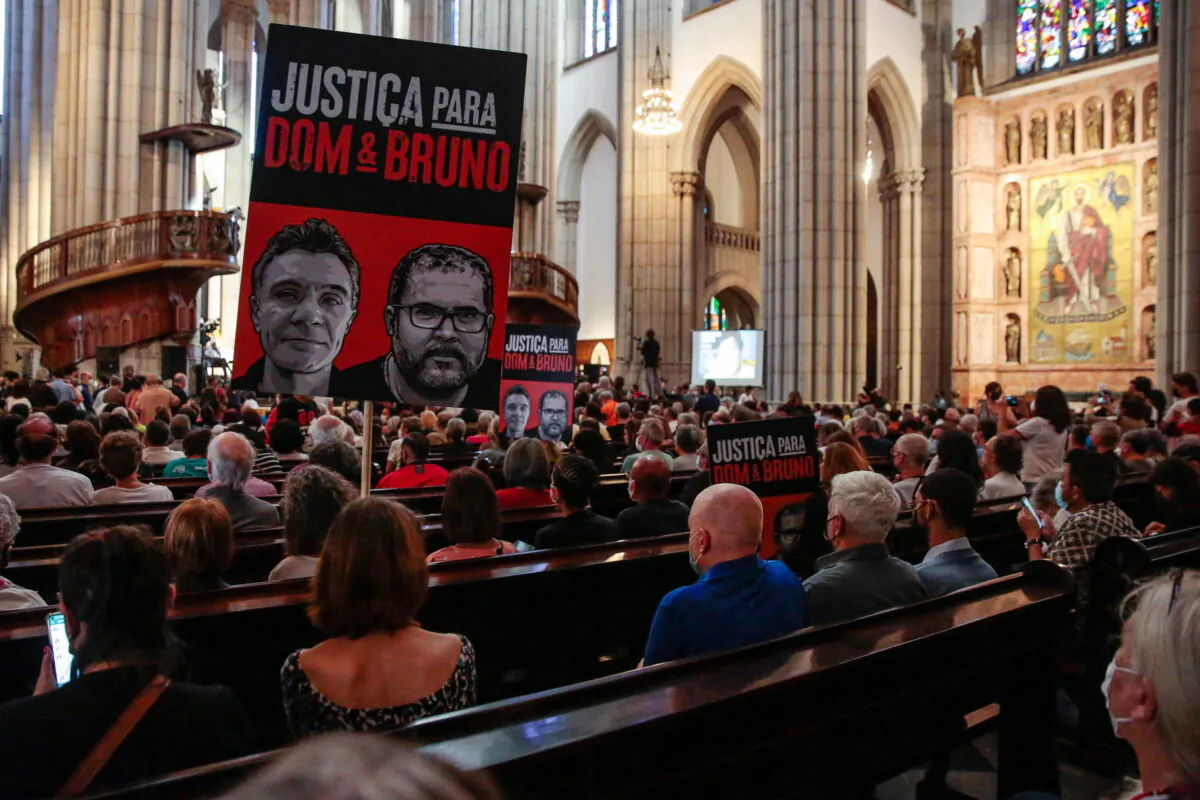 People attend a memorial service for indigenous expert Bruno Pereira and British journalist Dom Phillips, who were murdered in the Amazon, in Sao Paulo, Brazil on July 16, 2022. (Suamy Beydoun/Reuters)