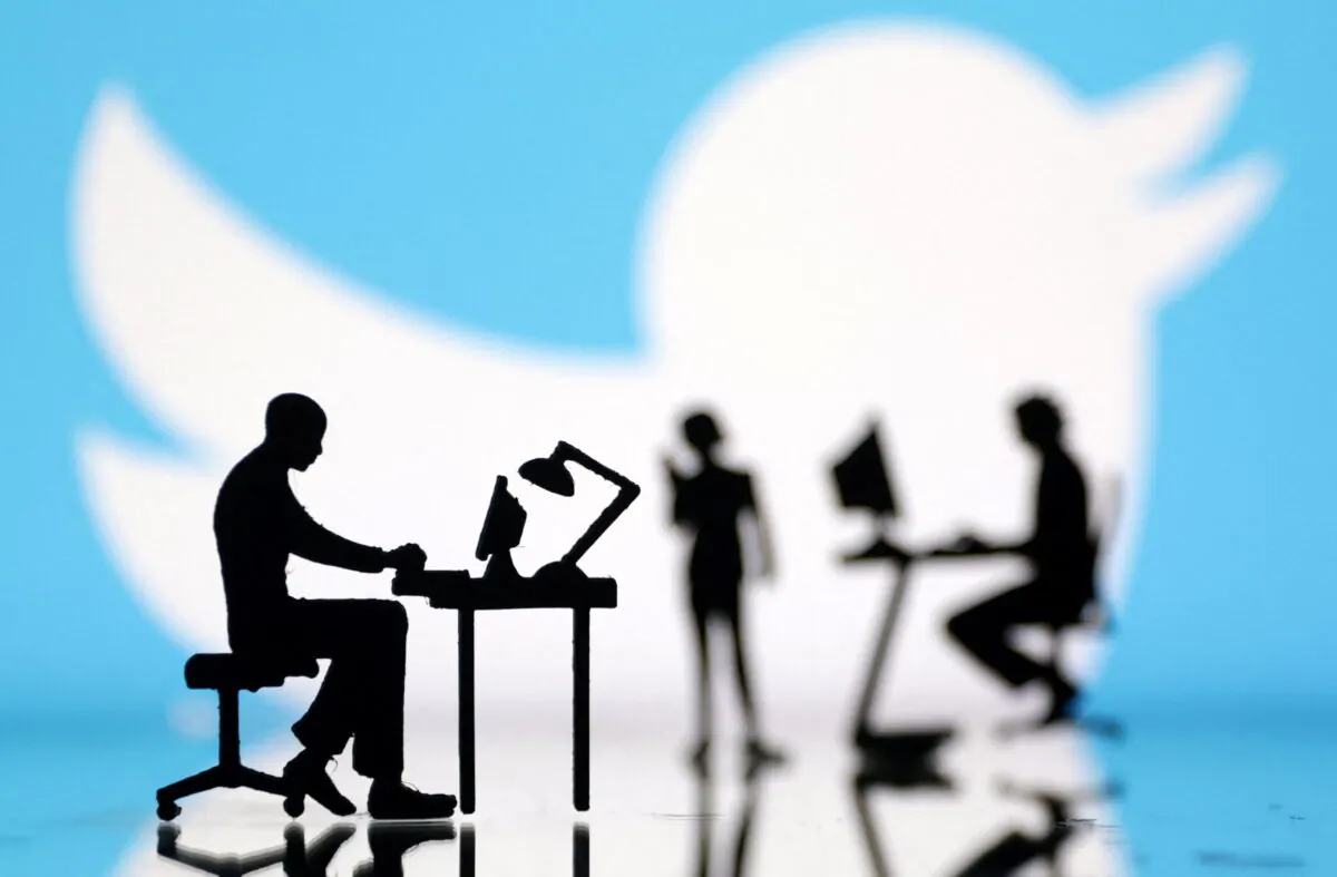 Figurines with computers and smartphones in front of Twitter logo in a photo illustration on July 24, 2022. (Dado Ruvic/Illustration/Reuters)