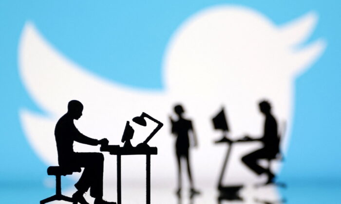 Figurines with computers and smartphones in front of Twitter logo in a photo illustration on July 24, 2022. (Dado Ruvic/Illustration/Reuters)