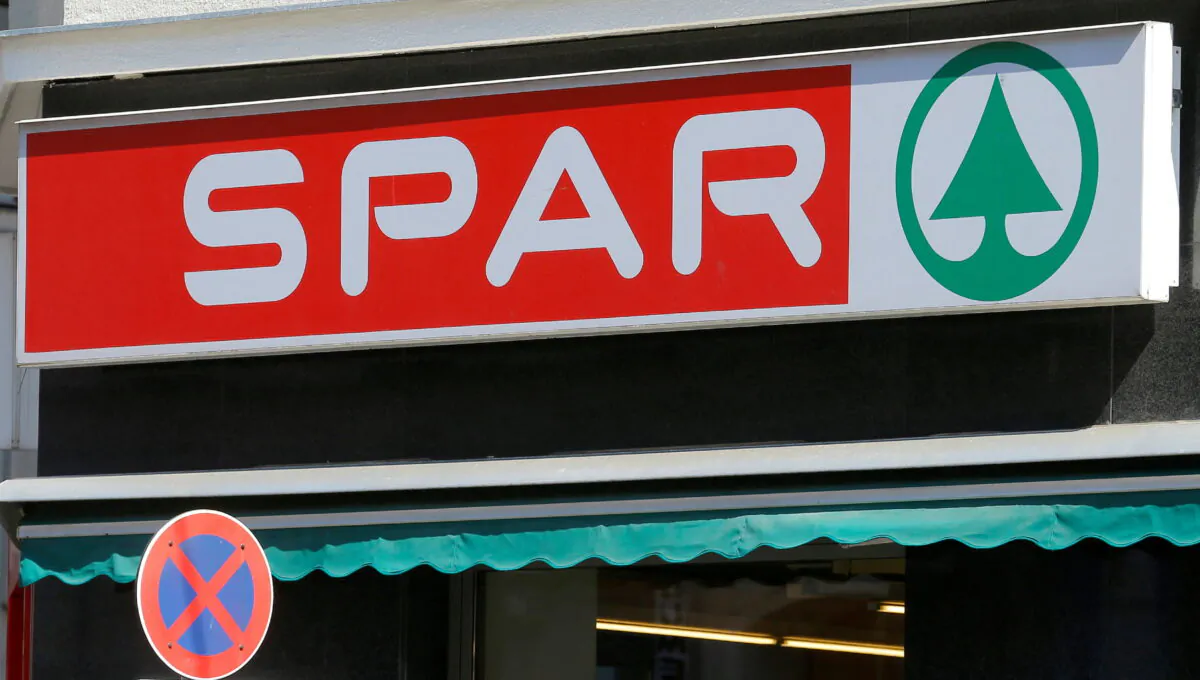 The logo of Austrian supermarket chain Spar is seen behind a traffic sign at a shop in Vienna, on July 11, 2016. (Heinz-Peter Bader/Reuters)
