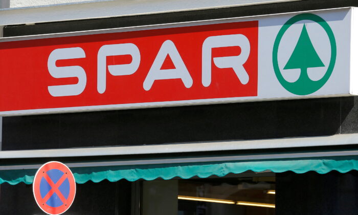 The logo of Austrian supermarket chain Spar is seen behind a traffic sign at a shop in Vienna, on July 11, 2016. (Heinz-Peter Bader/Reuters)