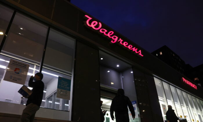 People walk by a Walgreens in Manhattan, New York, on Nov. 26, 2021. (Andrew Kelly/Reuters)