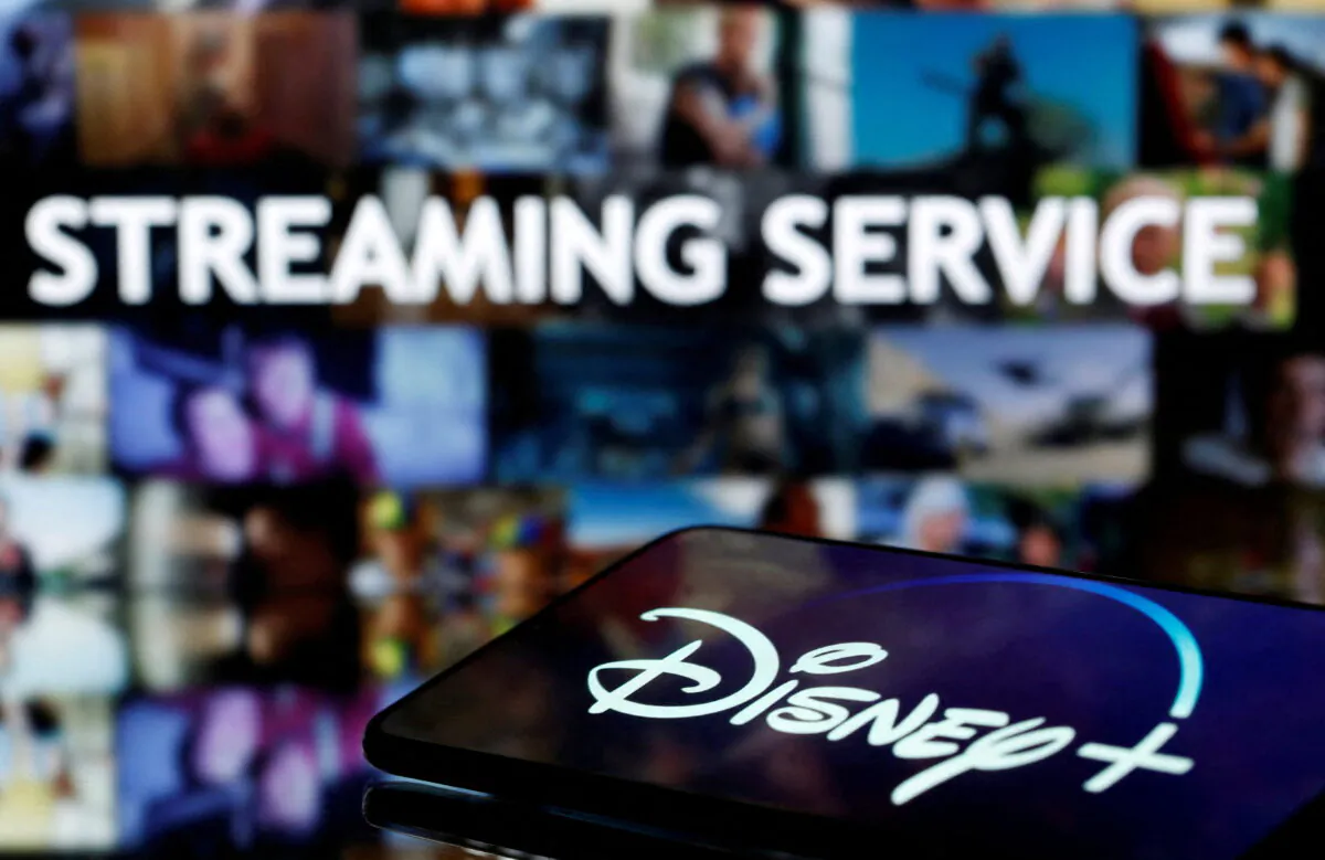 A smartphone screen showing the "Disney+" logo in front of the words "streaming service" in this illustration on March 24, 2020. (Dado Ruvic/Reuters)