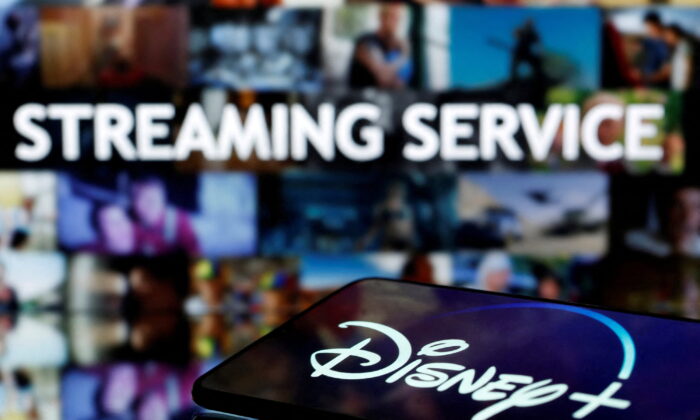 A smartphone screen showing the "Disney+" logo in front of the words "streaming service" in this illustration on March 24, 2020. (Dado Ruvic/Reuters)