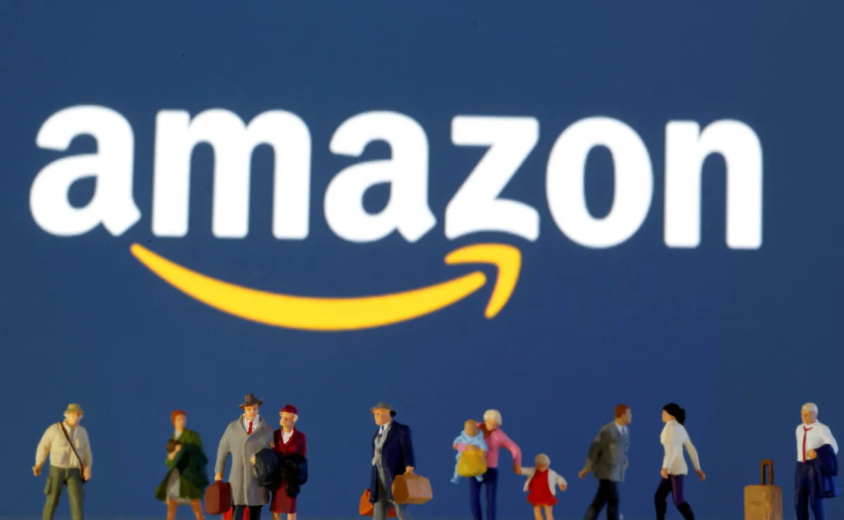 Small toy figures in front of displayed Amazon logo in this illustration taken on March 19, 2020. (Dado Ruvic/Illustration/Reuters)